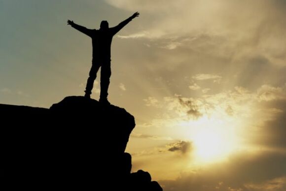 man at the top of the mountain